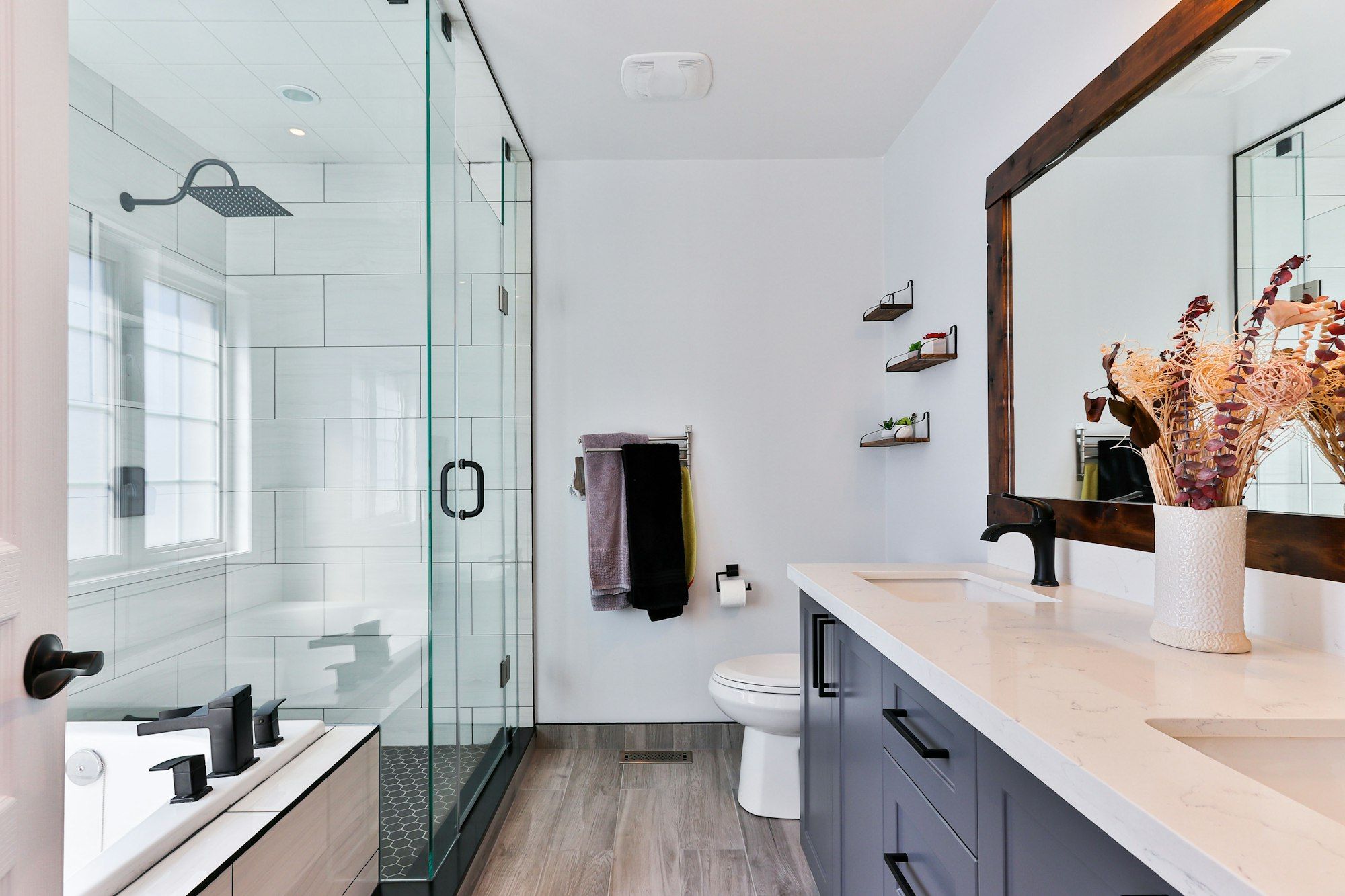 Bathroom remodel in Raleigh NC with tiled walk-in shower and modern vanity